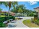 Charming home with a brick paved driveway, manicured garden beds, and mature trees at 407 Fieldstone Dr, Venice, FL 34292