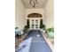Welcoming entrance featuring a branded rug, comfortable seating, and elegant potted plants at 407 Fieldstone Dr, Venice, FL 34292