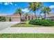Charming one-story home featuring a tile roof, two-car garage, and mature landscaping at 407 Fieldstone Dr, Venice, FL 34292