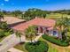 Stunning single-story home boasts tile roof, lush landscaping, and desirable golf course views at 407 Fieldstone Dr, Venice, FL 34292