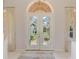 Elegant front entrance featuring double doors with etched herons and light tile flooring at 407 Fieldstone Dr, Venice, FL 34292