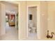 Hallway view into the Primary bedroom and a separate water closet in a neutral color palette at 407 Fieldstone Dr, Venice, FL 34292