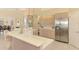 Bright kitchen with stainless steel appliances and views into the dining area at 407 Fieldstone Dr, Venice, FL 34292