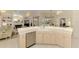 Bright kitchen with countertop and view into fireplace and open shelving in the living area at 407 Fieldstone Dr, Venice, FL 34292