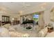 Bright living area featuring comfortable seating, a piano, and a view of the outdoor space at 407 Fieldstone Dr, Venice, FL 34292