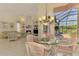 Cozy living room and dining area with screened in patio at 407 Fieldstone Dr, Venice, FL 34292