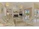Inviting living room with a fireplace, built-in shelves, and access to the pool area at 407 Fieldstone Dr, Venice, FL 34292