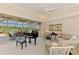 Bright living room with a piano, large windows overlooking the backyard at 407 Fieldstone Dr, Venice, FL 34292