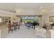 Open-concept living room features elegant decor, grand piano, and scenic views of the outdoors at 407 Fieldstone Dr, Venice, FL 34292