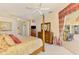 Spacious main bedroom featuring a four-poster bed, neutral walls, and an outdoor seating area at 407 Fieldstone Dr, Venice, FL 34292