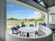Charming outdoor patio featuring round seating and picturesque views of the golf course and lush greenery at 407 Fieldstone Dr, Venice, FL 34292