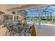 Inviting screened-in pool area with comfortable seating and picturesque golf course backdrop at 407 Fieldstone Dr, Venice, FL 34292