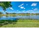 Expansive water view showcasing a serene lake surrounded by lush greenery under a bright, cloudy sky at 407 Fieldstone Dr, Venice, FL 34292
