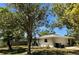 Back of a single-story home with a fenced in yard, a two-car garage, and a well-maintained lawn at 4170 Prudence Dr, Sarasota, FL 34235
