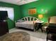 A bright bedroom featuring green walls, daybed and vintage furnishings at 4170 Prudence Dr, Sarasota, FL 34235