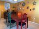 Dining room with wooden table, eclectic chairs, tile floor and vibrant gold walls at 4170 Prudence Dr, Sarasota, FL 34235