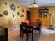 Dining room with wooden table, eclectic chairs, tile floor and vibrant gold walls at 4170 Prudence Dr, Sarasota, FL 34235