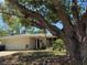 Charming single-story home with mature trees, a two-car garage, and a well-maintained front yard at 4170 Prudence Dr, Sarasota, FL 34235