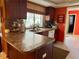 Open kitchen offers stone countertops, dual stainless sink, and bright window views at 4170 Prudence Dr, Sarasota, FL 34235