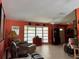 A cozy living room featuring tile flooring, a ceiling fan, and a large bay window at 4170 Prudence Dr, Sarasota, FL 34235