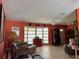 A cozy living room featuring tile flooring, a ceiling fan, and a large bay window at 4170 Prudence Dr, Sarasota, FL 34235