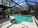 Inviting screened-in pool with views of the sky and lush landscaping at 4170 Prudence Dr, Sarasota, FL 34235