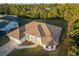 A bird's eye view of a well-maintained single Gathering home surrounded by lush greenery and neighboring houses at 4456 Callaway St, Port Charlotte, FL 33981
