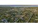Scenic aerial view of a residential area nestled amongst lush greenery and waterways, showcasing the tranquil setting at 4456 Callaway St, Port Charlotte, FL 33981