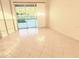An empty bedroom featuring tile floors, a large sliding glass door to the backyard and natural light at 4456 Callaway St, Port Charlotte, FL 33981
