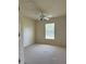 Bedroom with neutral carpet, a ceiling fan, and natural light from a window, offering a simple, comfortable space at 4456 Callaway St, Port Charlotte, FL 33981