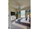 Furnished bedroom featuring a TV, sleek modern decor, neutral tones, and carpet, for a comfortable aesthetic at 4456 Callaway St, Port Charlotte, FL 33981