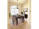 Formal dining room with a modern chandelier, large windows, and a dining table that seats six, perfect for Gathering gatherings at 4456 Callaway St, Port Charlotte, FL 33981