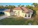 Charming single-story home featuring a stucco exterior, arched entryway, well-maintained landscaping, and an attached two-car garage at 4456 Callaway St, Port Charlotte, FL 33981