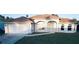 Front exterior view of house featuring a two-car garage, well-manicured lawn, and a beautiful front entryway at 4456 Callaway St, Port Charlotte, FL 33981