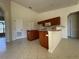 Spacious kitchen featuring wood cabinetry, a breakfast bar, and tile flooring, perfect for Gathering gatherings at 4456 Callaway St, Port Charlotte, FL 33981