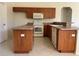 Well-lit kitchen features ample counter space, wooden cabinets, and modern appliances, perfect for culinary enthusiasts at 4456 Callaway St, Port Charlotte, FL 33981