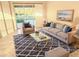 Cozy living room featuring neutral furniture, a stylish area rug, and a sliding glass door to the backyard at 4456 Callaway St, Port Charlotte, FL 33981