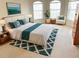 Stylishly furnished main bedroom features a cozy rug, artwork, and natural lighting for a comfortable atmosphere at 4456 Callaway St, Port Charlotte, FL 33981