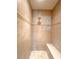 Elegant tiled shower showcasing decorative accents, a built-in bench, and a rainfall shower head at 4456 Callaway St, Port Charlotte, FL 33981
