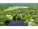Aerial view showcasing a beautiful lake, surrounding houses, and lush greenery at 4576 Cooper Rd, Sarasota, FL 34232