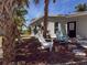 Charming backyard featuring Adirondack chairs and mature palm trees for relaxing outdoors at 4576 Cooper Rd, Sarasota, FL 34232