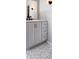 Modern bathroom with gray vanity and marble floors and matte black faucet at 4576 Cooper Rd, Sarasota, FL 34232