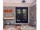 Inviting front entrance featuring a brick facade, decorative console table, and stylish double doors at 4576 Cooper Rd, Sarasota, FL 34232