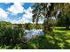 Scenic view of a tranquil lake reflecting the blue sky and lush greenery at 4576 Cooper Rd, Sarasota, FL 34232