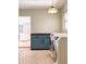 Bright laundry room with modern washer and dryer, blue cabinetry and herringbone floors at 4576 Cooper Rd, Sarasota, FL 34232