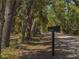 Property entrance with a clear sign and mature trees lining the driveway at 4576 Cooper Rd, Sarasota, FL 34232