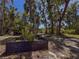 Landscaped yard featuring a garden box and mature trees, perfect for outdoor living at 4576 Cooper Rd, Sarasota, FL 34232