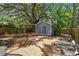 Backyard cottage nestled among trees, featuring a pergola and a seating area at 4741 Watkins Ave, Sarasota, FL 34233