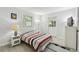 Cozy bedroom with neutral walls, a window, a door and tile floors, creating a serene retreat at 4741 Watkins Ave, Sarasota, FL 34233
