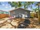 Cottage featuring gray siding and a backyard seating area, offering a cozy retreat at 4741 Watkins Ave, Sarasota, FL 34233